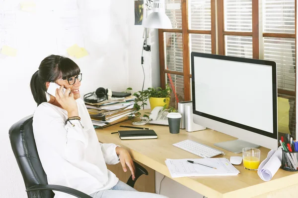 Young entrepreneur woman using cellphone on home office.