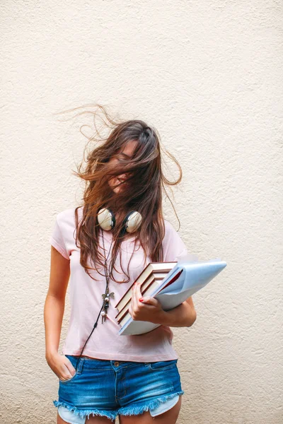 Portrait of a young student woman with flying hair.