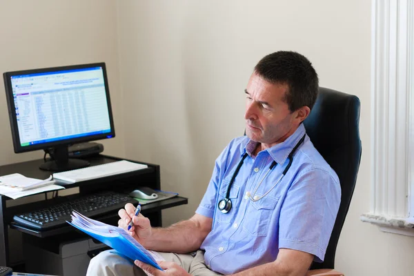 Doctor Writing On A Document