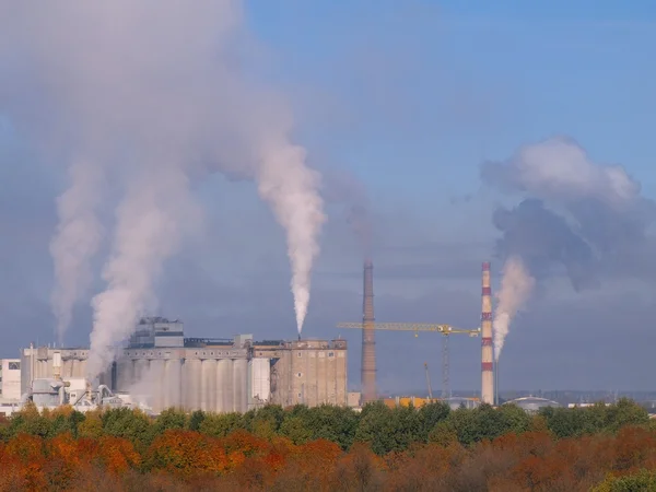 A heavy industry production plant with steam and fumes