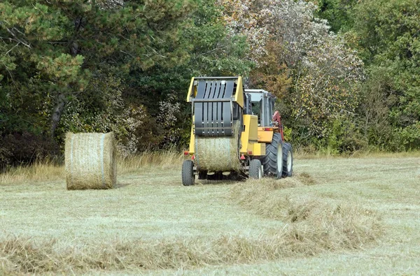 Agricultural machine to press bullets of hay, countryside in Burgundy (France)