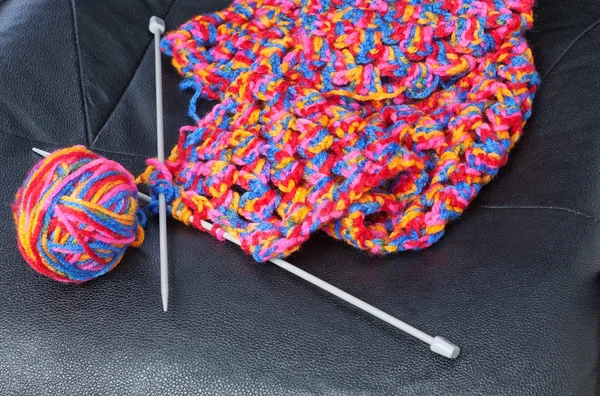 Product for knitting of colored threads on a leather chair.