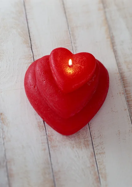 Heart shaped candle on hard wood block