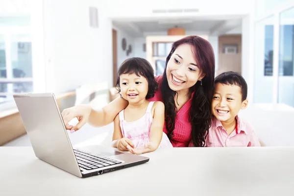 Happy family enjoying entertainment on laptop