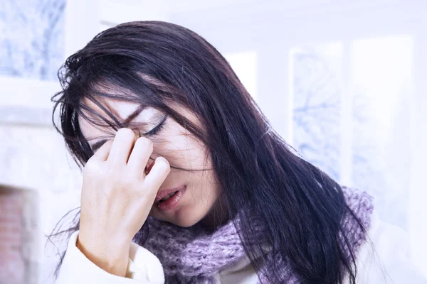 Woman with bad headache in winter
