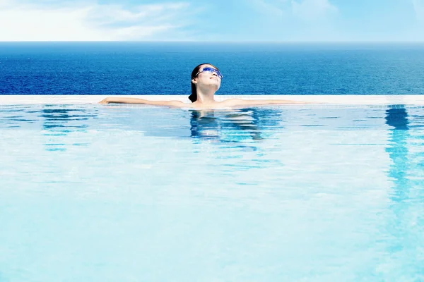 Beautiful woman relaxing in pool