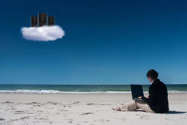 Cloud computing on beach with laptop
