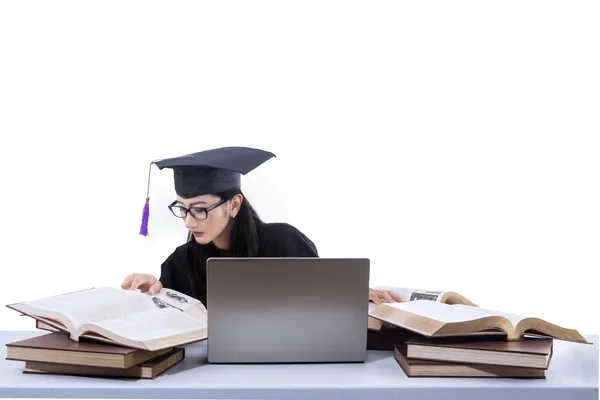 Busy female graduate reading books - isolated