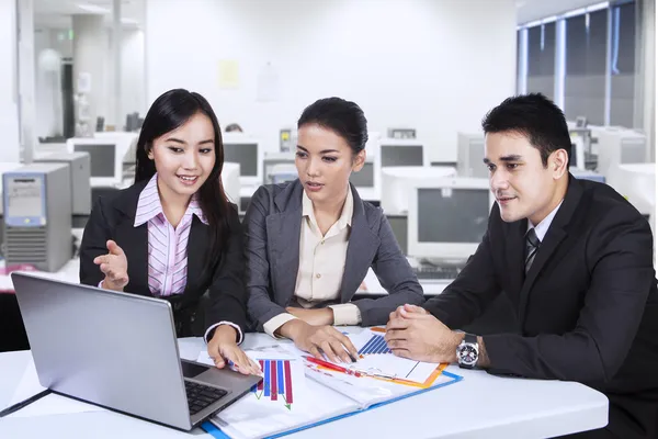 Three asian business team with laptop at office