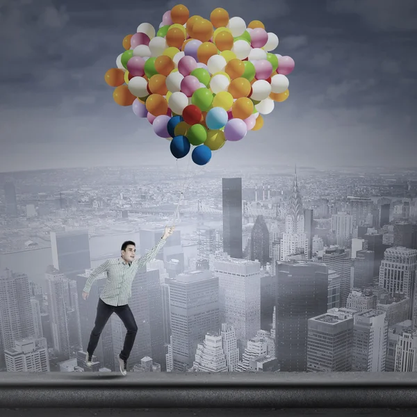 Man flying with balloons