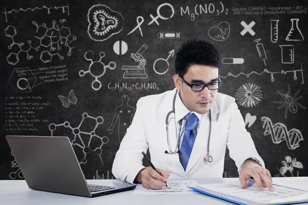 Young doctor working with notebook