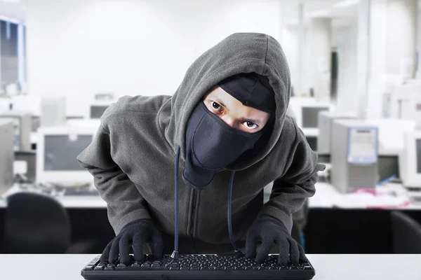 Hacker stealing business data at office