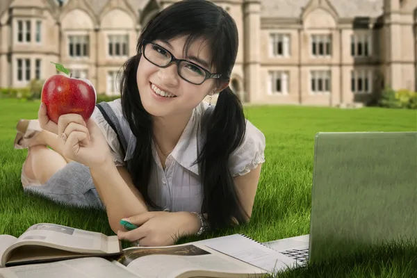 Attractive student studying at field