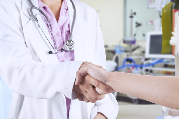 Doctor handshaking with patient