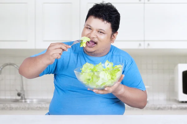 Obese person eats salad for diet 1