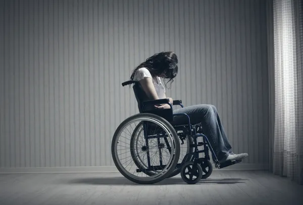 Crying woman sitting in wheelchair