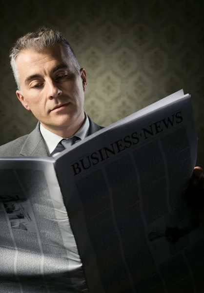 Businessman holding newspaper