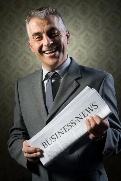Businessman holding newspaper