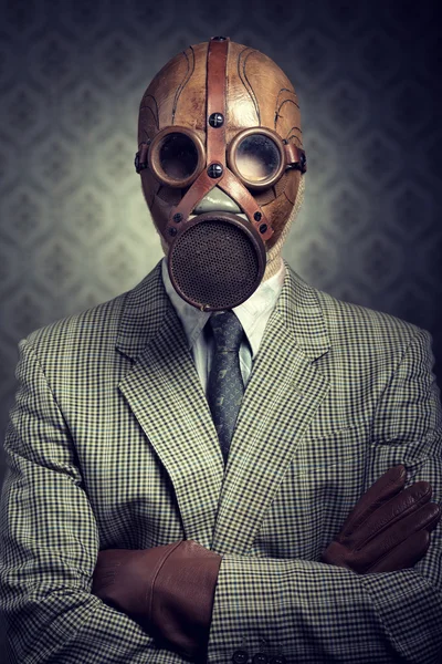 Vintage businessman wearing gas mask
