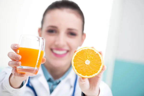 Doctor with glass of orange juice