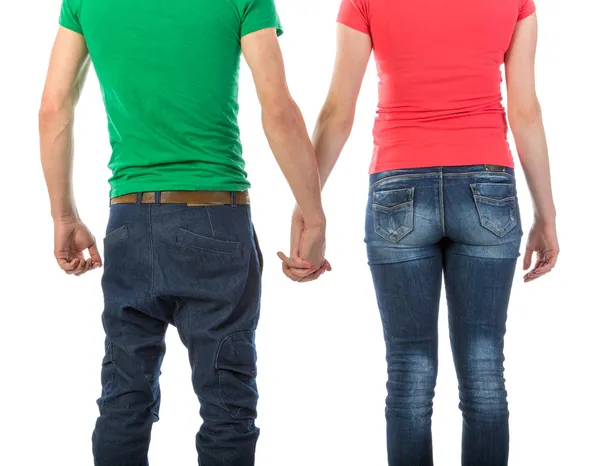 Young couple seen from behind holding hands on white Background