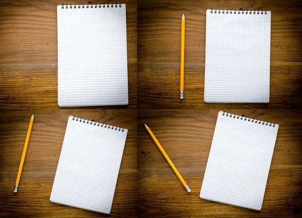 Black notebook with pencile on a wood background close up