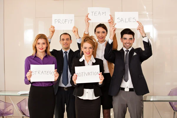 Team of business people holding cardboards