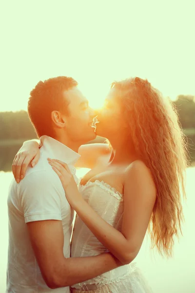 Loving couple hugging on the lake. Beauty young woman and man in
