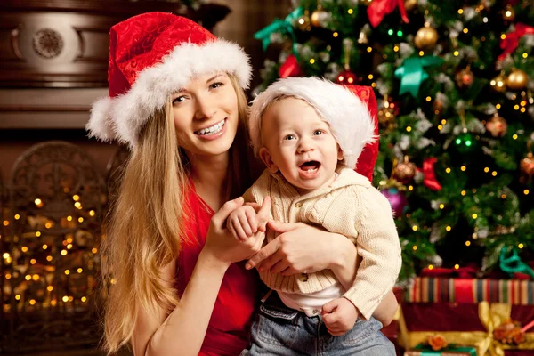 Happy smiling family near the Christmas tree celebrate New Year.