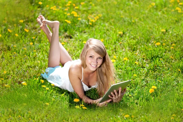 Beautiful smiling woman with tablet pc, outdoors. Beautiful youn