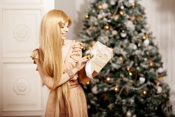 Luxury blonde in interior New Year. Young beauty trendy girl cel
