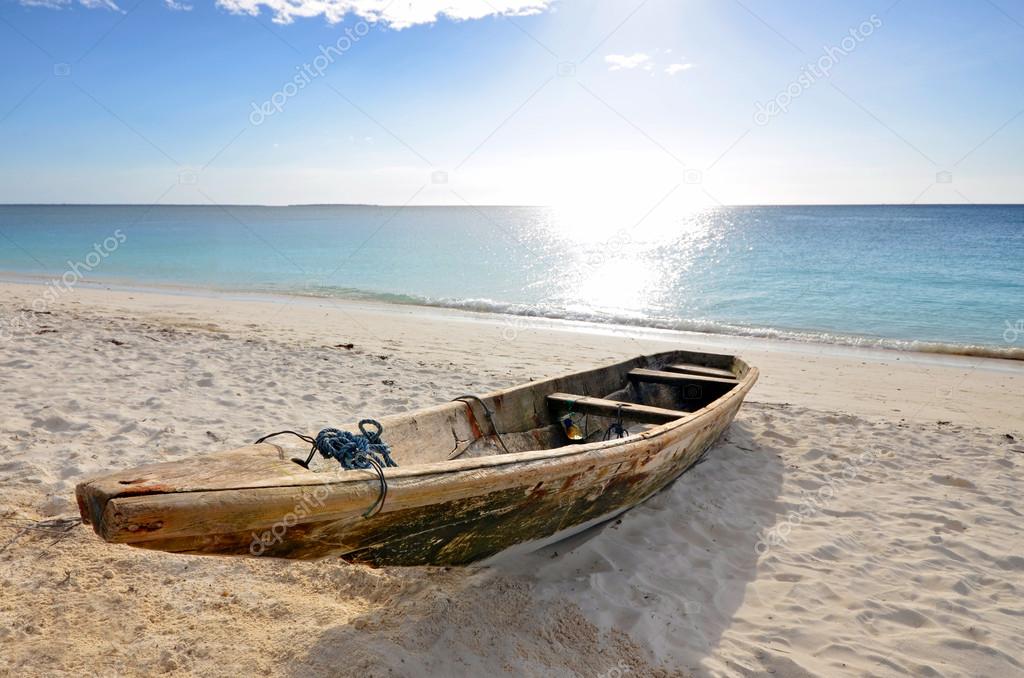 Wooden Fishing boat on a beach with blue sky — Stock Photo © tr3gi ...
