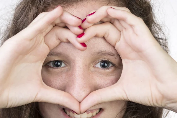 Teen with hands in heart shape
