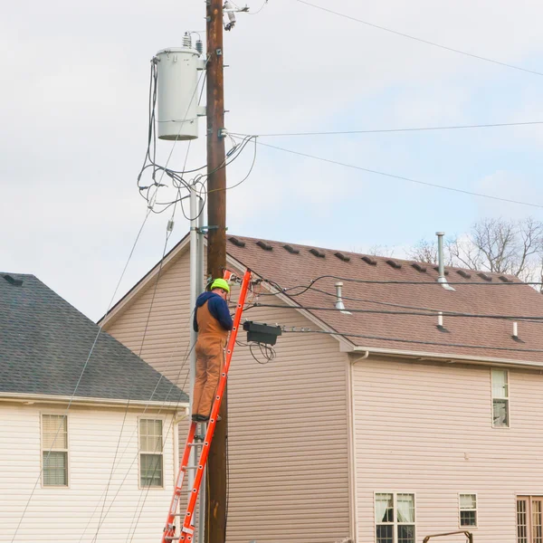 Electrician worker at electric power pole.
