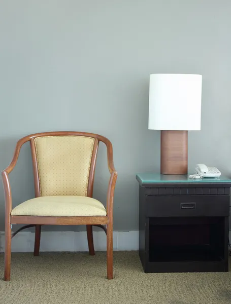 Chair and table lamp in bedroom