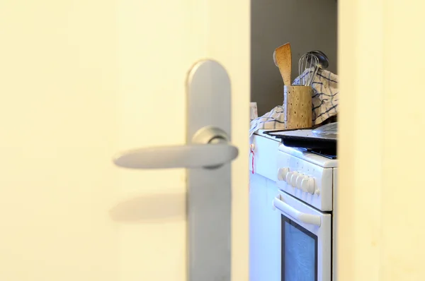 Mess in domestic kitchen through door