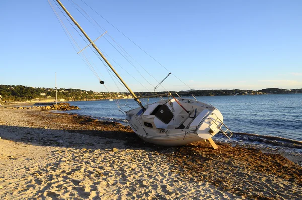 Sailboat Boat stranded on the beach after a storm