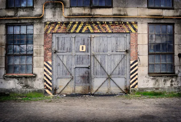 Abandoned old factory with closed door and windows