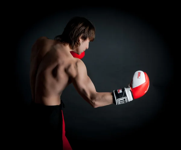 Man  boxing in black background
