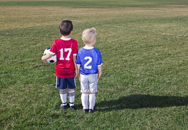 Two Young Soccer Players From Different Teams On A Grass Field Ready To Play
