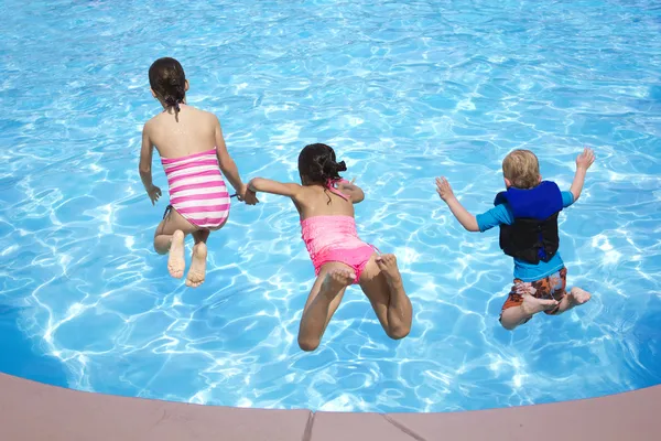 Three Kids Jumping Into The Swimming Pool Stock Images Page Everypixel