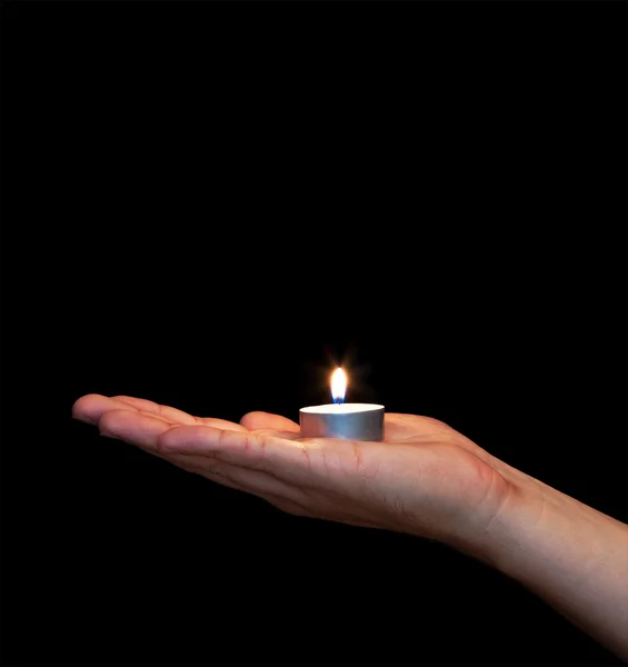 Man hand holding burning candle
