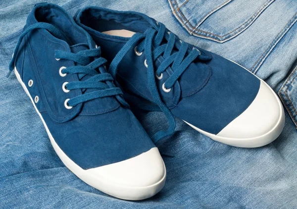 A pair of new blue shoes on a jeans