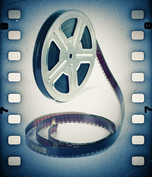 Old motion picture film reel with film strip. Vintage background