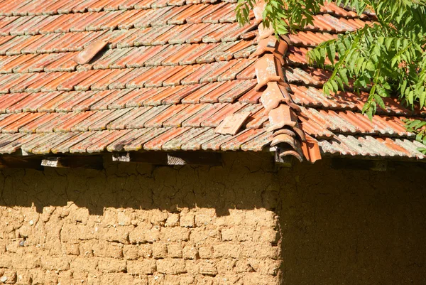 Mud brick rural building and red tiled roof