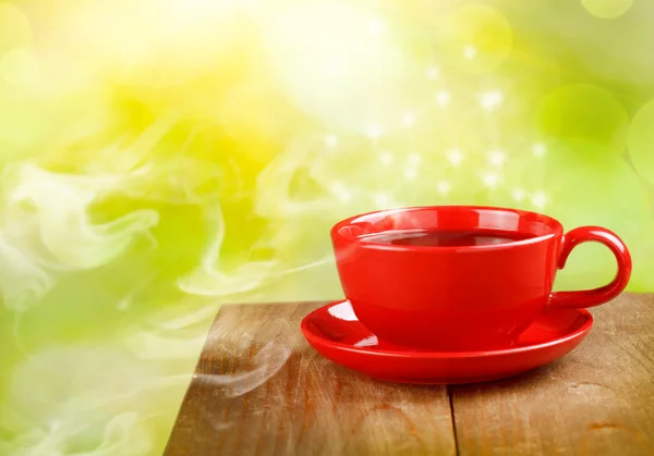 Cup of tea or coffee on magic sunny background