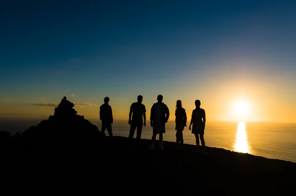 Group of travellers at sunset