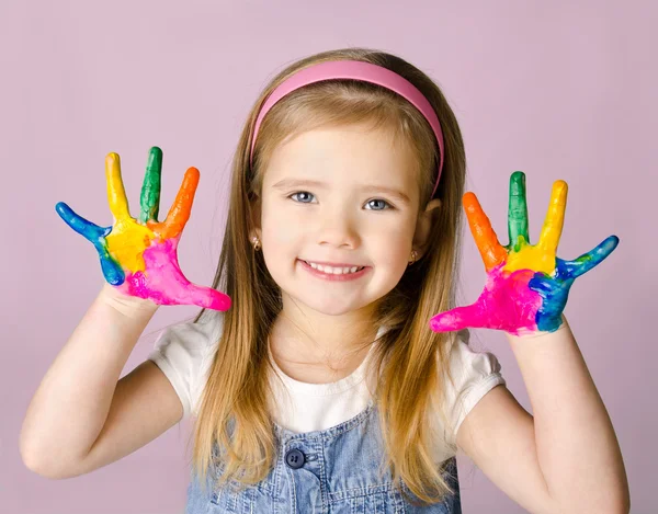 Smiling little girl with hands in the paint