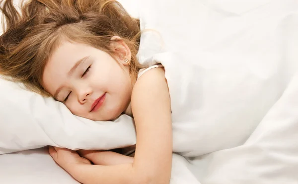 Little girl sleep in the bed close-up
