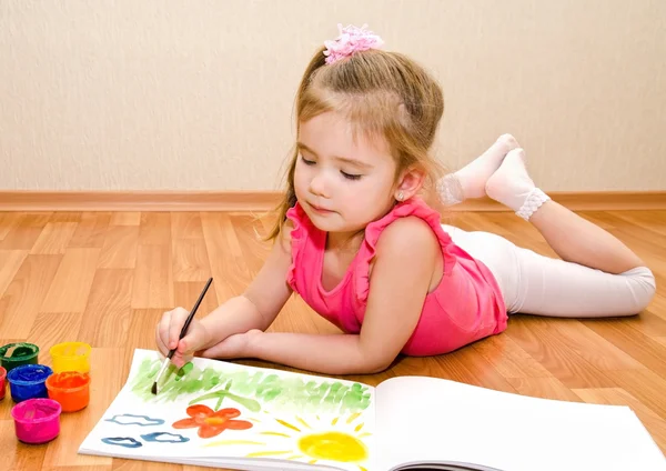 Little girl drawing with paint